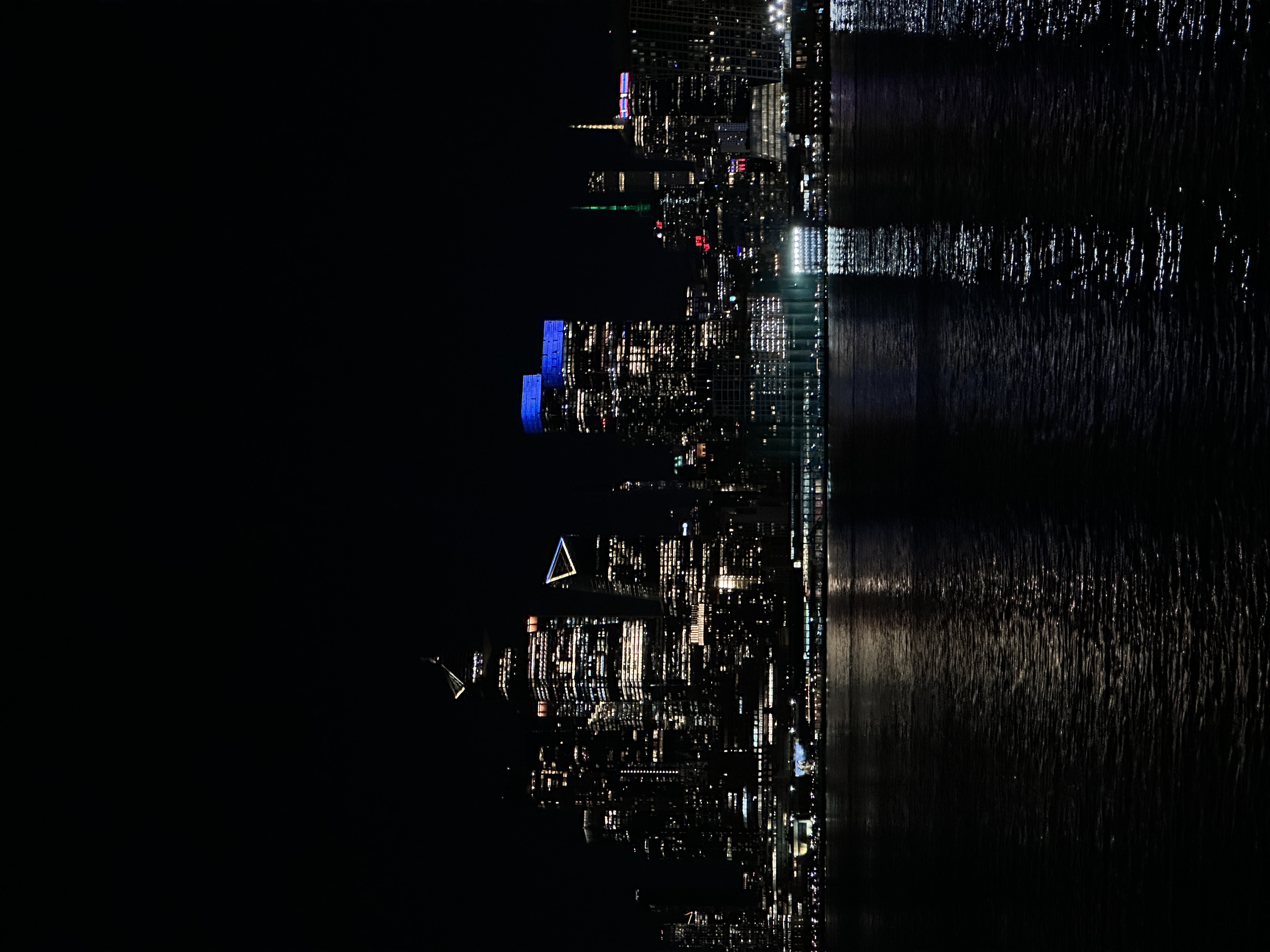 new york city skyline at night across the hudson river